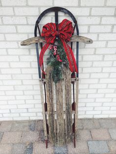 a wooden sled with a wreath tied to it