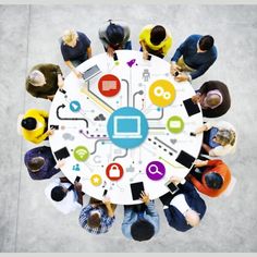 a group of people standing around a white table with various icons on it and the words social media