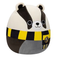 a stuffed panda bear is wearing a yellow and black striped hat with the hogwarts crest on it's chest