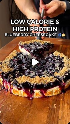 a blueberry cheesecake on a cutting board with the words low calorie & high protein