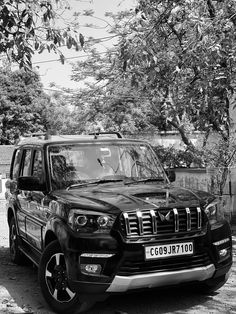 a black and white photo of a parked suv