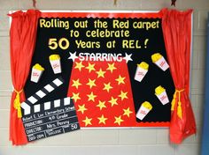 a red carpeted room with a sign that says, rolling out the red carpet to celebrate 50 years of rel