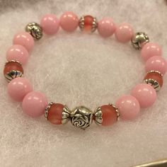 Offering A Brand New, One Of A Kind, Handmade Ladies Stretch Bracelet Made Of Genuine Pink Jade Beads Accented With (6) Rose Quartz Beads, (3) Silver Rose Beads, & Decorative Bead Caps. This Is A Lovely Bracelet In Shades Of Pink That Can Be Worn Alone Or Layered With Other Bracelets. It Is A Great Item To Keep & Even Greater To Gift! Pink Gemstone Bracelet, Rose Beads, Semi Precious Stone Bracelet, Pink Jade, Decorative Beads, Rose Quartz Beads, Quartz Beads, Pink Gemstones, Jade Beads