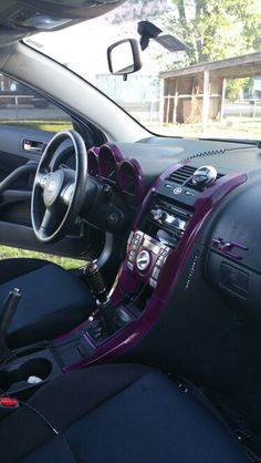 the interior of a car with purple trim