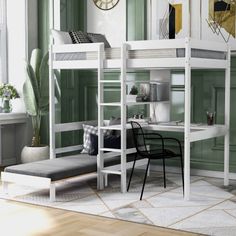 a loft bed with desk and chair in a green room next to a white couch