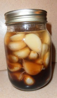 a glass jar filled with liquid sitting on top of a counter