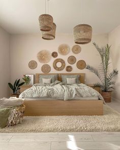 a bedroom with lots of wicker baskets hanging above the bed and rugs on the floor