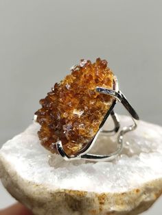 Make a Bold Statement with our Raw Citrine Ring! Elevate your style and showcase your unique personality with our exceptional Raw Citrine Ring. Crafted with a genuine, uncut citrine gemstone, this ring embodies the raw beauty of nature. The adjustable band ensures a perfect fit for any finger, providing both comfort and versatility. Made with sterling silver filled metal, this ring offers durability and a lustrous shine that complements the radiant citrine stone. Citrine is revered for its abili Raw Citrine, Raw Gemstone Ring, Ring Crystal, Raw Beauty, Yellow Citrine, Citrine Stone, Citrine Ring, Citrine Gemstone, Crystal Ring