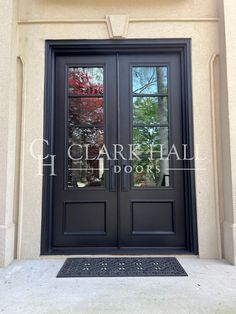 a black double door with two sidelights and glass panels on the front of a building