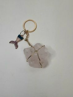 a keychain with a starfish charm hanging from it's side on a white surface