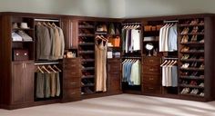 an open closet with clothes and shoes in it