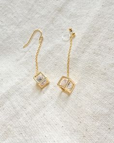 These gold Zircon cube earrings are perfect gift for bridesmaids, friends, sisters and mothers. They're dainty and delicate.  Please choose from wire hook or invisible clip on. Chain: gold filled 4cm Hook: gold filled Dangle Linear Earrings With Adjustable Chain As Gift, Adjustable Dangle Linear Earrings As Gift, Modern Threader Earrings With Adjustable Chain For Gifts, Elegant Rectangular Linear Earrings As Gift, Elegant Box Chain Threader Earrings For Gift, Elegant Threader Earrings With Box Chain For Gift, Minimalist Box Chain Threader Earrings Gift, Elegant Rectangular Linear Earrings For Gift, Tarnish Resistant Dangle Linear Earrings Gift