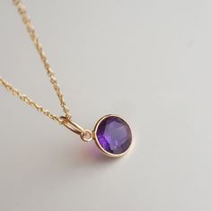 ✪Metal: 18k solid yellow gold ✪Gemstone: Amethyst ✪Stone size: 7 mm ✪Gold weight: 220 milligram ✪Bail size: 5 mm ✪Without bail: 10 mm ✪Setting type: Bezel wire setting If you need any other preferred stone please contact us. QUALITY OF MATERIALS: Metal: Most of our jewelry at JewelryMansion is made with precious metals like gold and silver. These metals are 100% non-allergic to our skin. Gemstone: All of our jewelry is made by handpicked gemstones. Due to the nature of these gemstones a slight variation in colors may be noticed between the pictures and the real piece. Although we guarantee that this is barely noticeable. Real gemstones naturally consists of inclusions. In other words these gemstones may have very small barely noticeable cracks trapped inside the stones. This characteristic Bezel Wire, Natural Coral, February Birth Stone, Birthstone Charms, Charm Gift, Amethyst Stone, Gold Pendant, Precious Metals, Solid Gold