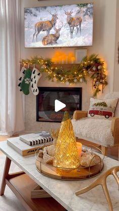 a living room decorated for christmas with deer decorations on the fireplace mantel and mantle