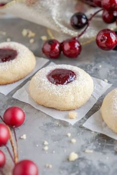 cranberry shortbreads with powdered sugar and fresh cherries on the side