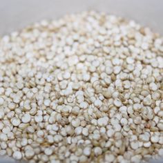 a bowl filled with white seeds on top of a table