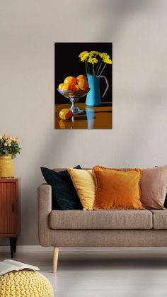 a living room with a couch, coffee table and vase filled with flowers on it