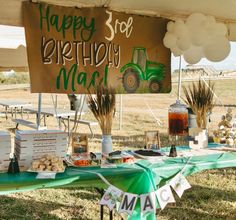 a tractor themed birthday party is set up under a tent