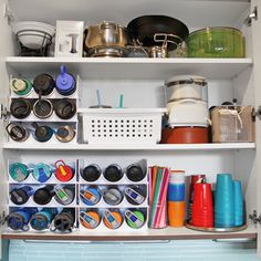 an open cabinet filled with pots and pans