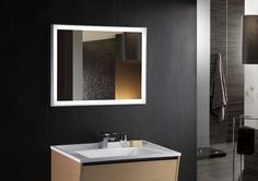 a bathroom with a sink, mirror and towel rack