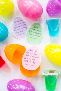 several colorful plastic cups with writing on them