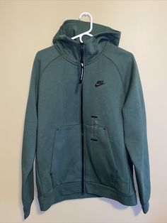 Nike Sportswear Tech Fleece Men's Full-Zip Hoodie Green Size M BV3701-337. Green Gym Hoodie With Drawstring Hood, Sports Half-zip Fleece Sweatshirt, Sports Half-zip Hoodie With Zipper Closure, Fleece Track Jacket With Long Sleeves For Sports Season, Fleece Long Sleeve Track Jacket For Sports Season, Half-zip Sports Sweatshirt With Zipper, Half-zip Sweatshirt With Zipper For Sports, Green Drawstring Hood Sweats For Sports, Half-zip Sweatshirt With Zipper Closure For Sports