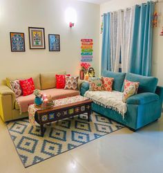 a living room filled with lots of furniture and colorful pillows on top of it's couches