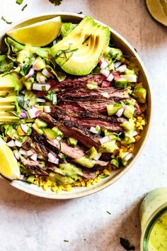 a bowl filled with corn, avocado and sliced meat on top of it