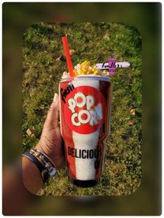 a person holding up a drink in their hand with the word pop o'clock written on it