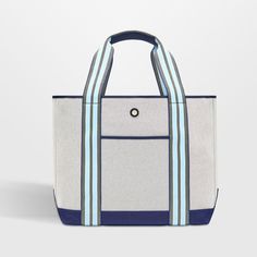 a white and blue tote bag sitting on top of a table