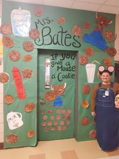 a woman standing in front of a door decorated with cookies and mouses on it