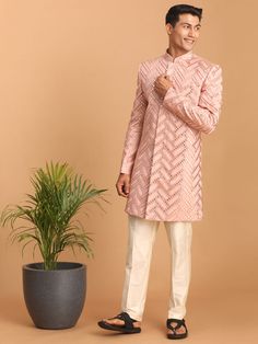 Pink Mirror Indo Western Sherwani Set Look your ethnic best in this stunning pink mirror work sherwani set. Crafted from a silk blend, this designer piece features a stylish fitted sherwani with a full-front button placket, long sleeves, and multiple slits. The cream-colored pants are designed for comfort with an elasticated waistband and button closure. Key Features Pink mirror work design Stylish fitted silhouette Full-front button placket Long sleeves with multiple slits Cream-colored solid p Mirror Work Design, Indo Western Sherwani, Pink Mirror, Work Design, Colored Pants, Indo Western, Mirror Work, Collar Top, Fitted Silhouette