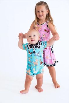 This shortie romper is an adorable one-piece outfit that's perfect for your favorite mini cowboy! The romper is crafted from bamboo viscose and spandex, making it gentle on sensitive skin, highly breathable, and durable. This outfit is an easy-wear choice that offers a comfortable fit and soft feel for your little one. The perfect outfit of the day in one adorable piece! Cute Fitted Onesie For Loungewear, Playful Fitted Onesie For Loungewear, Casual Fitted Bubble Romper For Loungewear, Playful Fitted Jumpsuits And Rompers For Loungewear, Short Sleeve Onesie For Summer Loungewear, Fitted Short Sleeve Onesie For Spring, Fitted Short-sleeved Onesie For Spring, Fitted Short Sleeve Casual Bubble Romper, Casual Fitted Short Sleeve Bubble Romper