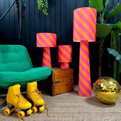 brightly colored roller skates are sitting in front of colorful lamps and floor lamp shades