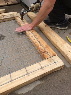 a man is working on some wood in the process of being made into a floor