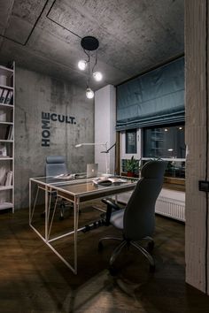 an office with a desk, chair and bookshelf