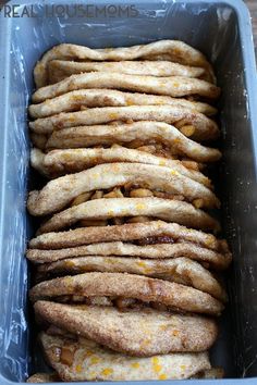 some bread sticks are in a plastic container