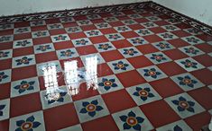 an old tiled floor with blue and red flowers on it in a room that is being renovated