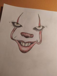 a drawing of a clown's face on paper