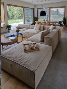 a living room filled with furniture and lots of windows