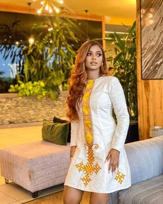 This gorgeous short Habesha Kemis is a true masterpiece, with an intricate Tilf design that adds a touch of elegance and tradition to the overall look. The Tilf embroidery is present on the neckline, sleeves, and hemline, creating a mesmerizing pattern that is both intricate and modern. The Kemis is made of luxurious Fetil material, which drapes beautifully on the body, creating a flattering silhouette. The Fetil material is soft and lightweight, making it perfect for a short dress that is appro White Dresses With Weaving Work For Traditional Ceremonies, Fitted Ceremonial Dress For Transitional Seasons, Fitted Dresses For Ceremonial Occasions, Traditional Fitted Dress With Motifs, Fitted Dress With Motifs For Festive Season, Festive Long Sleeve Dresses With Motifs, Traditional Fitted White Habesha Kemis, Traditional White Fitted Habesha Kemis, Traditional White Dress With Motifs