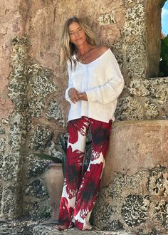 MANDY PANT RED HIBISCUS The Mandy Pant is a must-have piece in your LaRue wardrobe! Its comfort and versatility make it perfect for dressing up or down. Make it yours by pairing it with your favorite top and our signature kaftans - a style combo that will be sure to turn heads! Each Individual piece has a unique and eye-catching print. Drawstring waist Straight relaxed leg 100% Crepe De Chine Hand Wash or Delicate Cycle and Hang Dry The print is an original Ramona La Rue hand painted by the desi Floral Print Bottoms For Fall Vacation, Floral Print Bottoms For Vacation In Fall, Chic Fall Vacation Bottoms, Chic Red Loungewear Bottoms, Casual Long Pants For Holiday, Red Wide-leg Vacation Pants, Red Wide-leg Pants For Vacation, Fall Vacation Wide Leg Pants, Chic Red Floral Print Bottoms