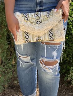 Don't leave for your vacay without the Daniella Beige Multi Beaded Fringe Clutch! This cute canvas clutch features gold rectangular shaped embellishments, rows of stunning Aztec inspired print and fun fringe. Lift the top from the hidden magnetic closure to find a side pocket. Attach the strap to wear as a crossbody. Bronze hardware. 12” x 8” measurements Beige Bohemian Clutch For Spring, Summer Embellished Rectangular Clutch, Bohemian Summer Travel Clutch, Beach Clutch With Fringe, Rectangular, Bohemian Summer Clutch With Tassels, Summer Gold Clutch For Everyday Use, Bohemian Rectangular Clutch For Spring, Gold Clutch For Everyday Summer Use, Bohemian Rectangular Spring Clutch