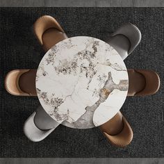 an overhead view of a marble table and chairs