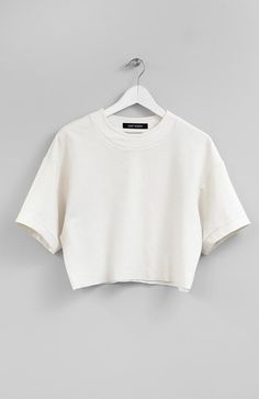 Color: IvoryFabric: 65% Rayon, 30% Nylon, 5% SpandexCare: Machine Wash Cold/ Tumble Dry Low Raw-edge jersey tee. 18.5' (47cm) long. Made in USA. Crop Tees For Women, Off White Cotton Crew Neck Top, Off White Relaxed Fit Crew Neck Tops, Cream Short Sleeve Top For Streetwear, Basic Cream Crew Neck Top, Cream Crew Neck Top For Streetwear, Cream Stretch Crew Neck Top, Basic Cream Tops With Relaxed Fit, Sporty Beige Crew Neck Top