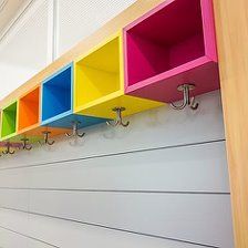 the colorful shelfs have hooks on them