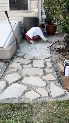 a man laying on top of a stone walkway