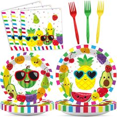 an assortment of party supplies including plates, forks and napkins with fruit on them