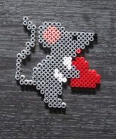 a pixellated photo of a mouse holding a red heart