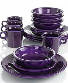 purple dishes are stacked on top of each other